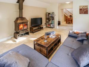 a living room with a couch and a fireplace at Paws In The Pines in Frithville