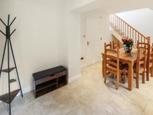 a kitchen and dining room with a table and chairs at Paws In The Pines in Frithville +13 photos
