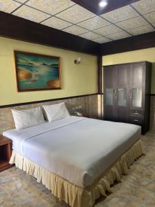 a large bed in a room with a large bed sidx sidx at Kata Palace Phuket Hotel in Kata Beach