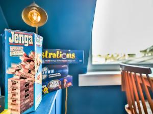 a shelf with a stack of jenga games on it at Sea View in Hollington