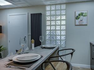 a dining room with a table with plates and wine glasses at The Old Post Office - Uk49450 in Haltwhistle