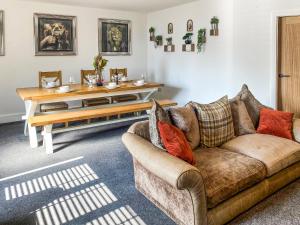 a living room with a couch and a table at The Pines in Redruth