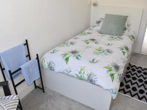 a bedroom with a bed with a pillow on it at Trinity Bee in Ventnor +7 photos