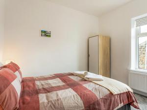 a bedroom with a bed and a refrigerator at Castle Retreat in Skipton