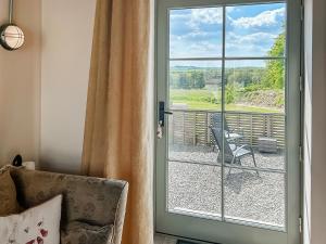 a sliding glass door with a view of a patio at The Tractor Barn - Uk49678 in Bratton Fleming
