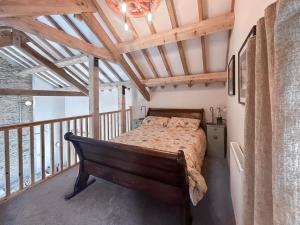 a bedroom with a bed on a balcony at The Tractor Barn - Uk49678 in Bratton Fleming +10 photos