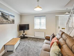 a living room with a couch and a flat screen tv at Aynsley Mews in Consett