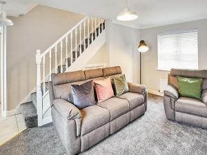 a living room with a couch and a chair at Aynsley Mews in Consett