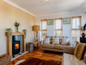 a living room with a couch and a fireplace at Baobab Lodge in Prestatyn