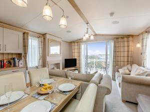 a living room with a couch and a table at Bay View 34 in Weymouth +12 photos