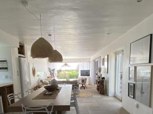 a living room with a table and a dining room at Namaste - Sea-facing 4 sleeper Holiday Home in Paternoster