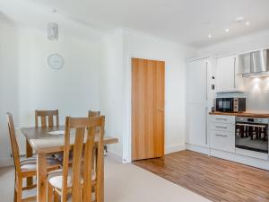 a kitchen and dining room with a table and chairs at Bay View in Shanklin