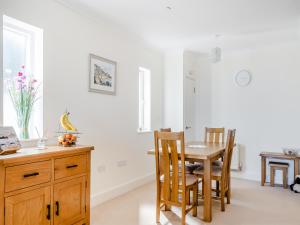a kitchen with a dining room table and chairs at Bay View in Shanklin