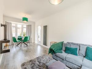 a living room with a couch and a table at Driftwood Villa in Brixham