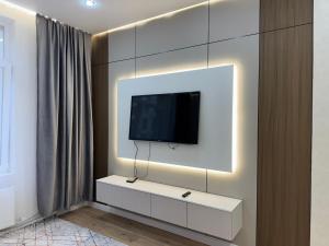 a living room with a tv on a wall at Buqar Jyrau Exclusive Business Residental Complex in Astana +15 photos