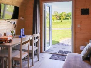 a room with a table and a sliding glass door at Awel Deg - Uk49672 in Brynsiencyn