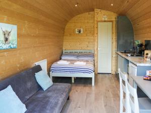 a room with a couch and a bed in a kitchen at Awel Deg - Uk49672 in Brynsiencyn