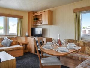 a living room with a table with chairs and a couch at The Getaway - Uk49617 in Lancaster