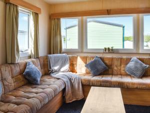 a leather couch in a living room with windows at The Getaway - Uk49617 in Lancaster