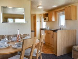 a kitchen and dining room with a table and chairs at The Getaway - Uk49617 in Lancaster