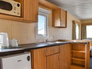 a small kitchen with a sink and a microwave at The Getaway - Uk49617 in Lancaster