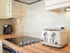 a toaster sitting on top of a kitchen counter at Doorstones Cottage in Moorside