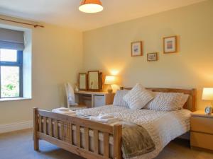 a bedroom with a bed and a window at Doorstones Cottage in Moorside +13 photos