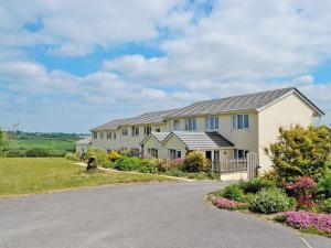 a large house with a driveway at Chaffinch Apartment - Uk49307 in Woolfardisworthy