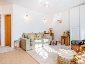 a living room with a couch and a table at Nook Cottage in Durham
