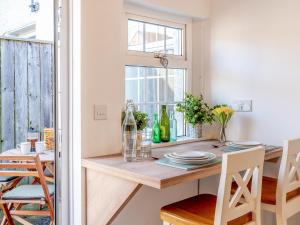 a dining room with a table and a window at Nook Cottage in Durham