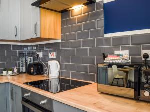 a kitchen with a sink and a counter top at South Pier Apartment in Blackpool