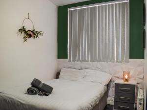a bedroom with a bed with a window and a window at South Pier Apartment in Blackpool +5 photos