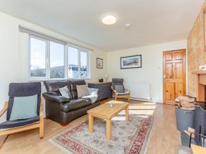 a living room with a couch and a table at Walled Cottage - Uk49097 in Inchnadamph
