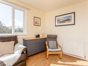 a bedroom with a desk and a chair and a bed at Walled Cottage - Uk49097 in Inchnadamph