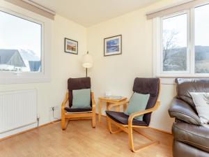 a living room with two chairs and a couch at Walled Cottage - Uk49097 in Inchnadamph