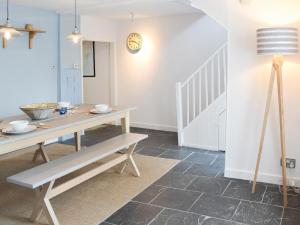 a dining room with a table and a bench at 33 Chapel Street in Penzance