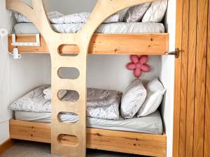 a bunk bed with two beds in a room at Waverley Cottage in Mundesley +7 photos