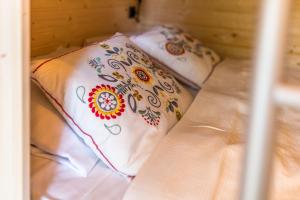a couple of pillows sitting on top of a bed at Ribno Alpine Glamping in Bled +38 photos