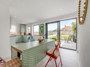 a kitchen and dining room with a table and chairs at Beach House in Seaford