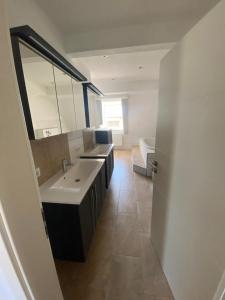 a bathroom with a sink and a large mirror at Vorverkauf Penthouse Loft Bamberg in Bamberg