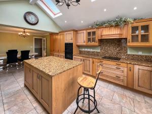 a large kitchen with wooden cabinets and a counter at Violet Bank in Cockermouth
