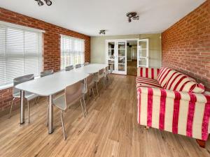 a room with a table and chairs and a brick wall at Violet Bank in Cockermouth