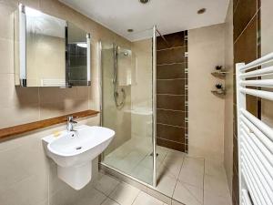 a bathroom with a glass shower and a sink at Violet Bank in Cockermouth