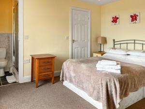 a bedroom with a bed and a bathroom with a sink at Middle Farm in Durham