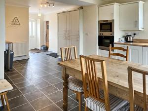a kitchen and dining room with a wooden table and chairs at Middle Farm in Durham