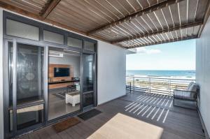 a balcony of a house with a view of the ocean at Executive Apartment with Ocean Views in Blouberg in Big Bay