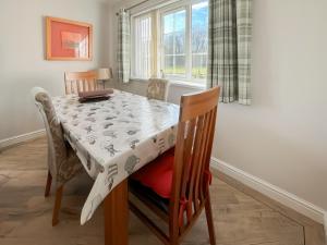 a dining room with a table and chairs and a window at Bramble - Uk49172 in Burgh le Marsh