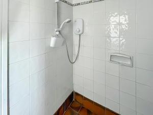 a shower in a bathroom with white tiled walls at Bramble - Uk49172 in Burgh le Marsh
