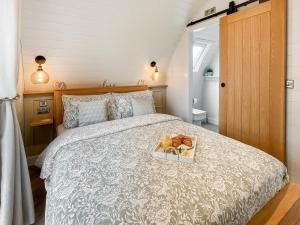 a bedroom with a bed with a tray of fruit on it at Lotties Lodge - Uk49905 