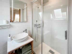 a white bathroom with a sink and a shower at Lotties Lodge - Uk49905 